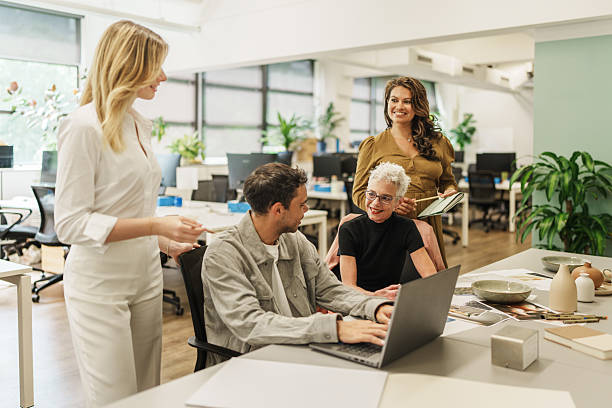 istock Focused group of professionals sharing ideas in a modern creative setting 2208071238
