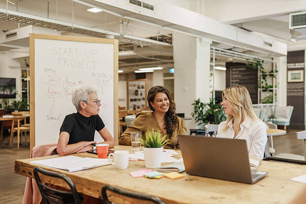istock Diverse team of women discussing a startup project in a creative workspace 2208071816