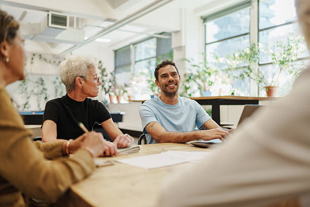 istock Inclusive team gathering for discussion in a modern open workplace 2208071856
