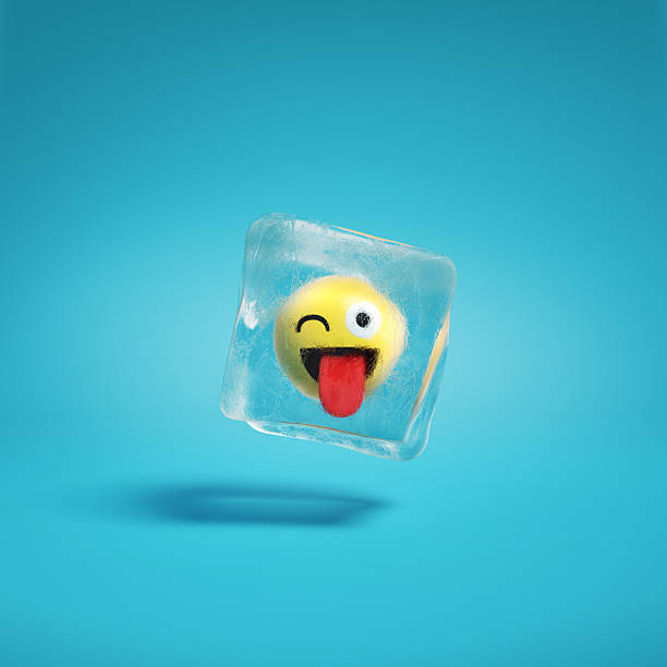 Zany wink emoticon face with crazy smile frozen in ice lump. Happy smile emoticon frozen in ice block background mockup concept illustration.