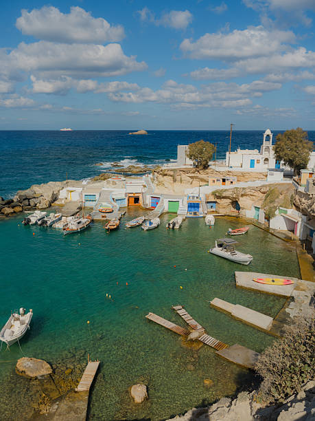 Quaint fishing village with boats in harbour  in Milos, Greece