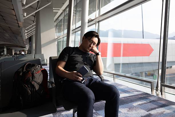 istock A man napping in the departure lounge 2208073710