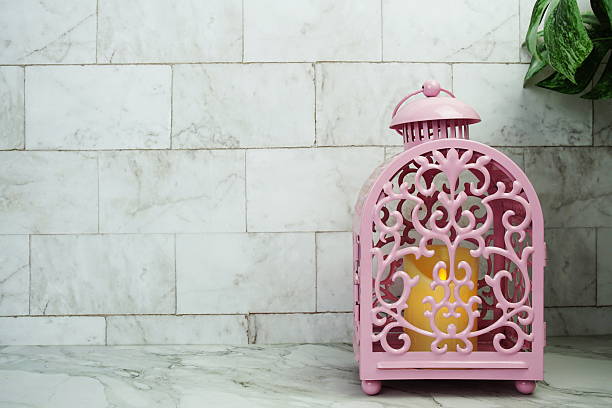 Pink candle light lantern home decoration on marble background