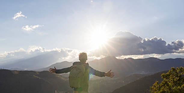 istock Mature man celebrates on mountain top at sunrise 2208077261