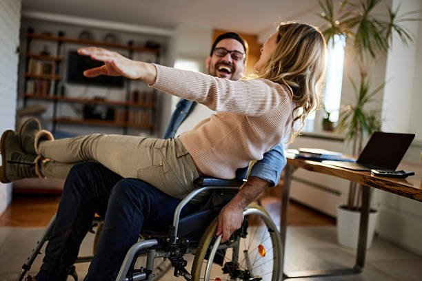 istock Happy disabled man having fun with his girlfriend at home. 2208078648