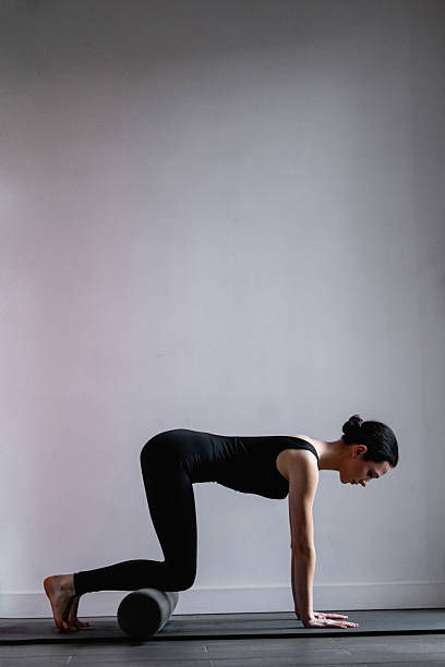 istock A girl is doing Pilates and yoga exercises using Pilates exercise props. 2208080281