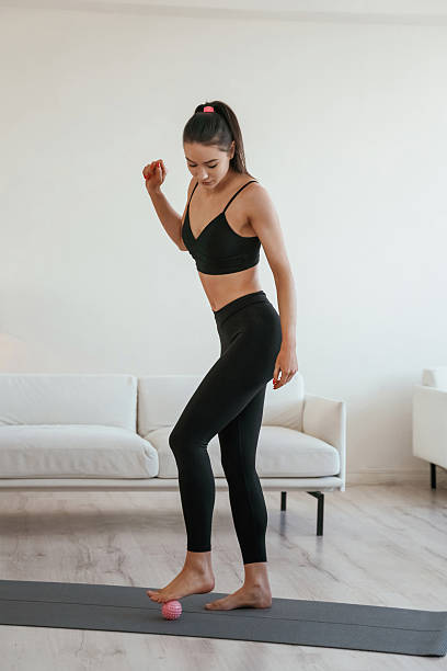 istock Small massage roller. Young woman with slim body type is indoors 2208081964