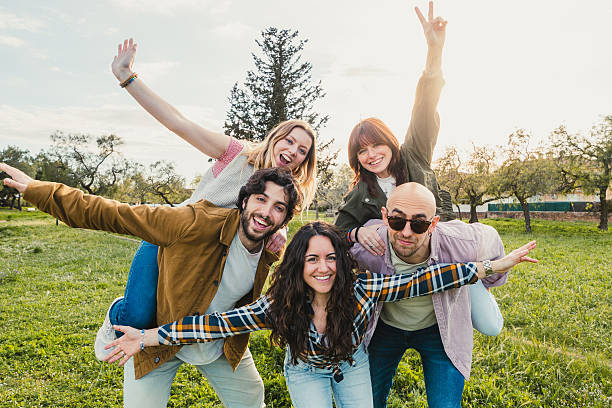 istock Group of Friends Having Fun and Posing in Field at Sunset 2208082136