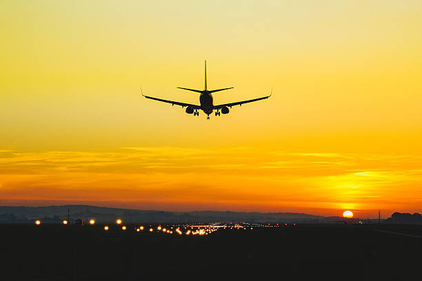 istock Airplane landing on the runway during sunset and dusk 2208083654