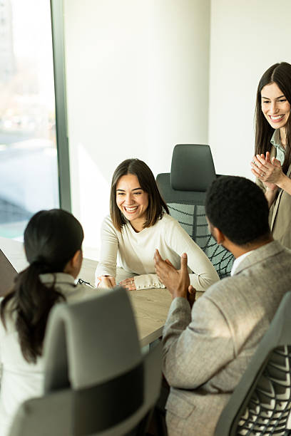 istock Professionals engage in a collaborative discussion during a bright office meeting 2208084344