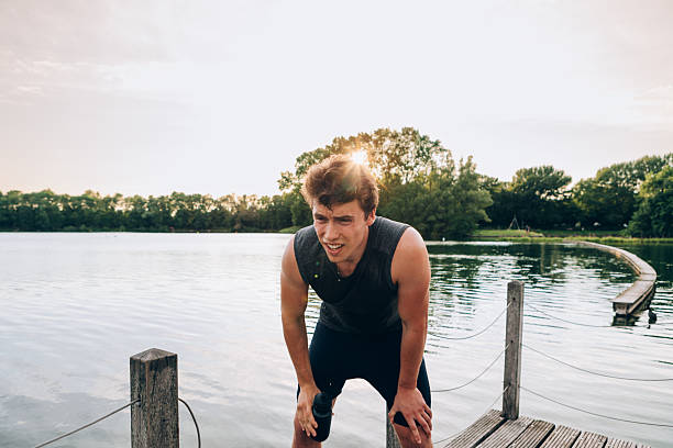 istock Exhausted sportsman taking a break after training outdoors 2208084364