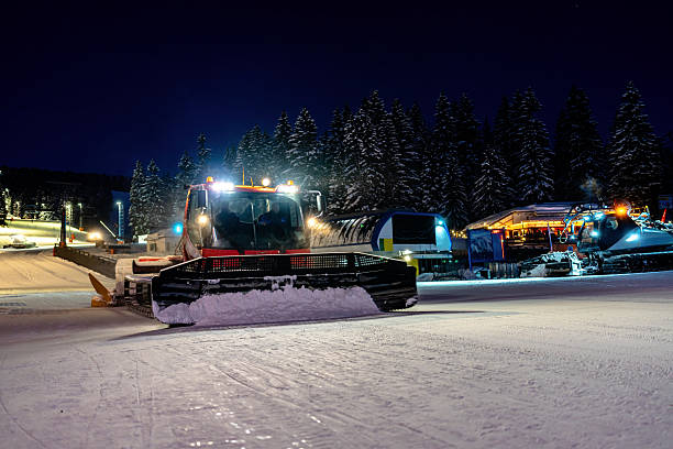 istock Snow groomer operating at a ski resort during the nighttime 2208084633