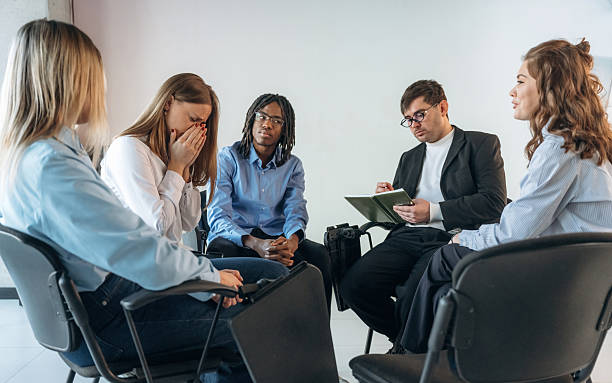 istock Therapist is with notepad. People are in group psychological support room together 2208085092