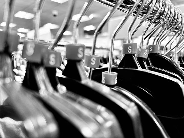 A row of clothes hangers in a retail environment