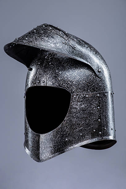 istock Medieval Knight's Helmet with Hinged Visor. This image shows a medieval knight's helmet, likely made of steel, with a rounded top and a hinged visor that can be lifted 2208089484
