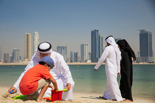 istock Grandfather and little boy playing on the beach 2208089492