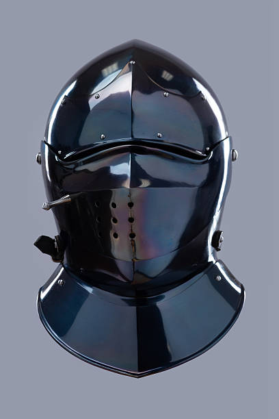 istock Dark Shiny Closed Helmet with Ventilation Holes. This image shows a dark, shiny helmet, possibly made of blackened steel, with a smooth, rounded shape and several small ventilation holes on the front. 2208089734