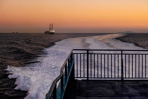 A vivid Seattle sunset on Elliott bay With a Ferry and smoke from wildfires.