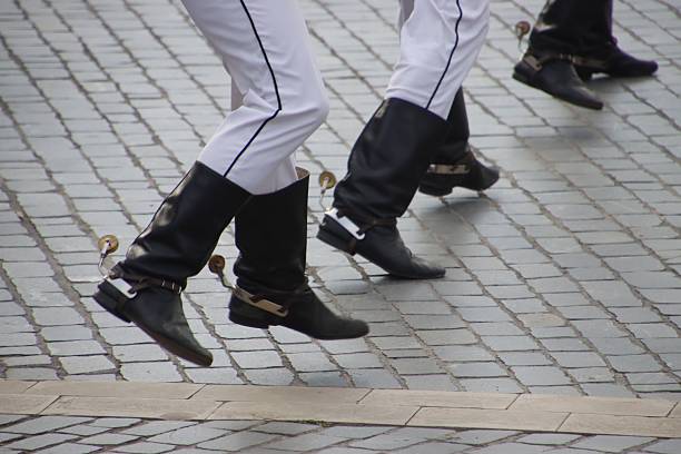 istock Traditional dancers' legs in black boots and white pants. 2208091627