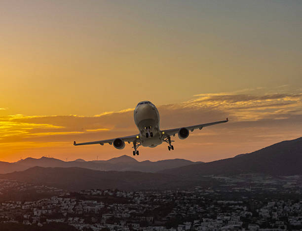 istock Passenger plane taking off over the city at sunset. 2208092840