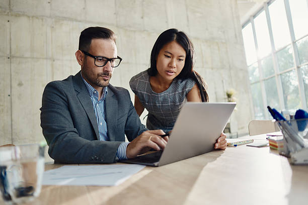 istock Diverse business colleagues working on laptop in the office. 2208093962