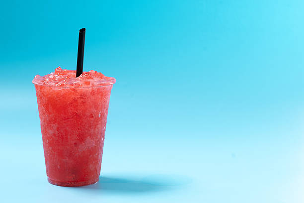 istock Red strawberry slushie isolated on blue background. Cold summer drink 2208093996