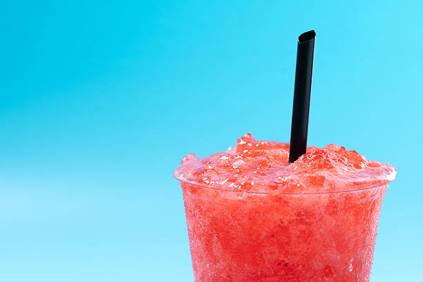 istock Red strawberry slushie isolated on blue background. Cold summer drink 2208094016