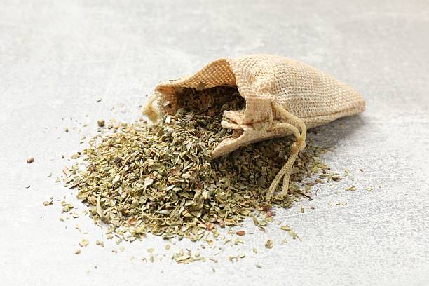 istock Sack with dried oregano on grey table, closeup 2208094503