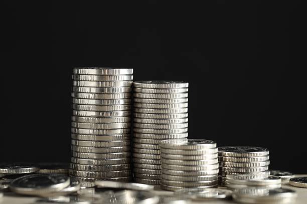 istock Stacked coins on table against black background, closeup. Salary concept 2208096422