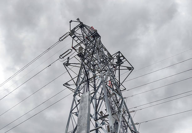 istock High-voltage power transmission tower against cloudy sky. 2208098316