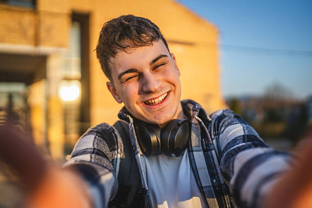 istock self portrait of young man wear backpack in front university building 2208098825