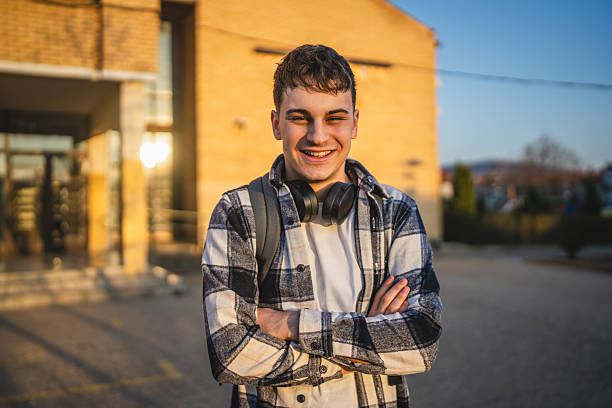 istock young man with wear backpack in front university building 2208098872