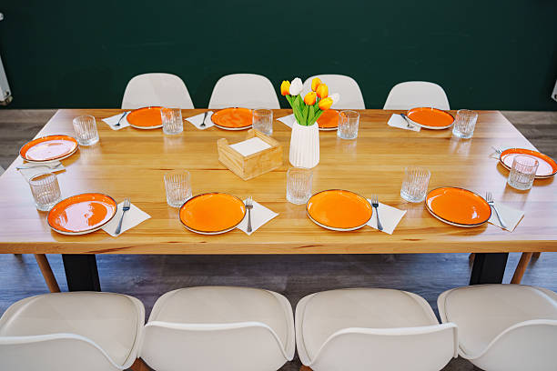istock Cozy dining table set with colorful plates and flowers 2208099588