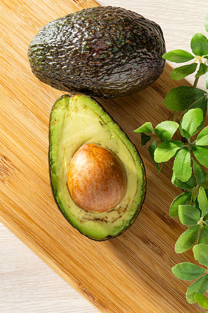 istock Fresh organic avocado on wooden table 2208099632