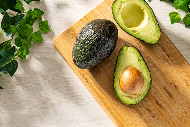 istock Fresh organic avocado on wooden table 2208099648