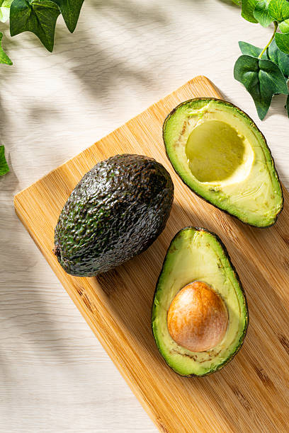 istock Fresh organic avocado on wooden table 2208099662