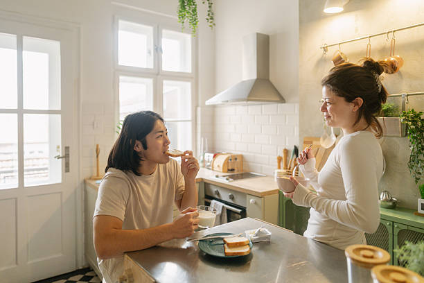 istock Young couple having breakfast in their kitchen 2208101469