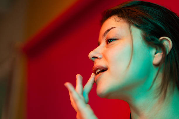 Photo of a beautiful young woman doing lip scrub