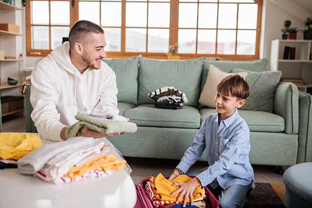 istock Young man packing a back with a boy at home 2208103120