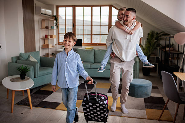 istock Uncle, niece and nephew preparing for a trip together 2208103184