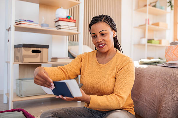 istock Woman packing a suitcase for a trip at home 2208103414