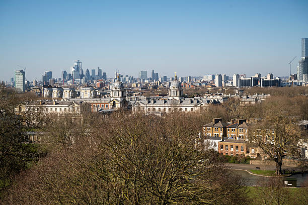 A breathtaking view from Greenwich Park, showcasing the historic Old Royal Naval College with London’s modern skyline, including The Shard and The Gherkin, rising in the background.