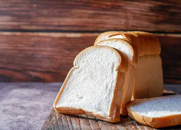 istock A stack of  white bread slices against Bread Sliced on Wooden Cutting Board 2208104517