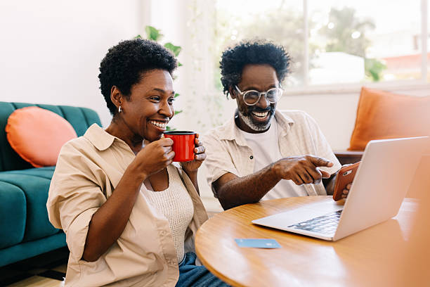 istock Couple watching a funny video together on a laptop 2208104789