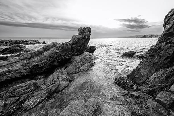 View of the sea cliffs at springtime sunset in Nervi, one of the east neighborhoods of the city of Genoa (Ligurian Region, Northern Italy). The city is famous for its commercial and touristic port.