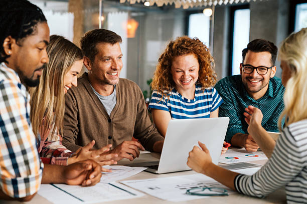 istock Group of young multi-ethnic startup business team collaborating on project in modern office 2208105686