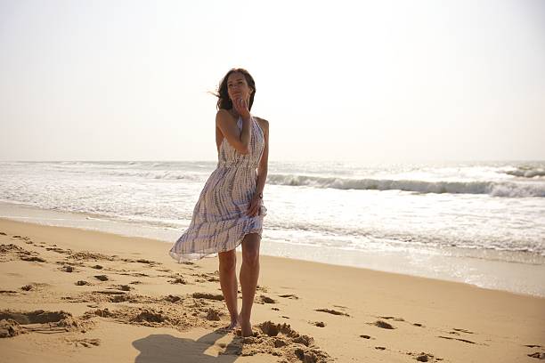 istock Woman Posing Gracefully on Sunny Beach 2208105839