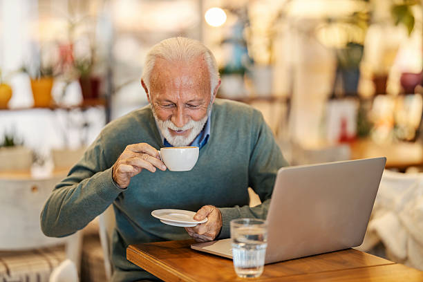 istock Smiling elegant senior man sitting in cafe and drinking coffee. 2208106250