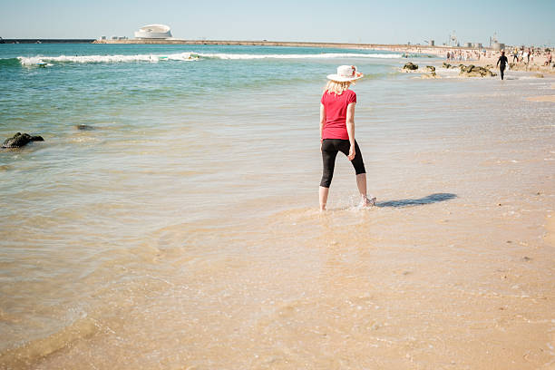 Tourist walking on the beach enjoying summer vacation