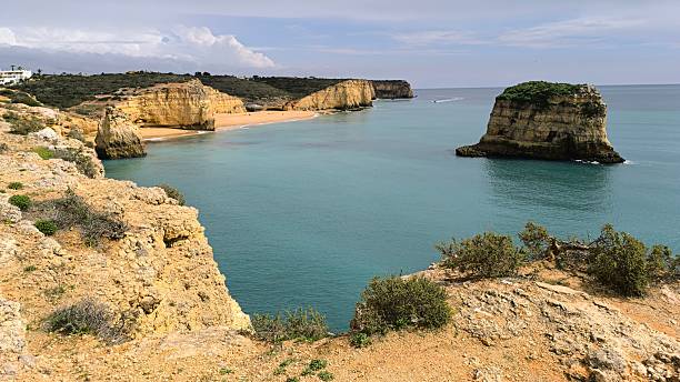 istock Idyllic Rock Island with Green Water 2208107583
